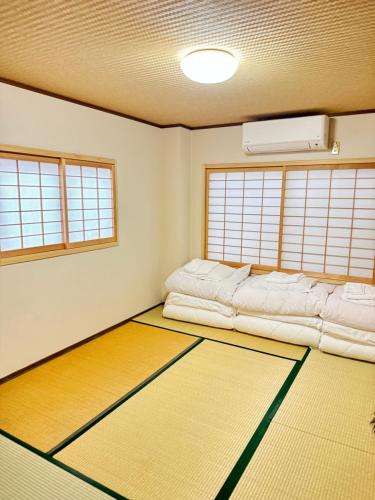 a room with two bean bags and two windows at Ikoi-no-Ie Guesthouse in Kyoto