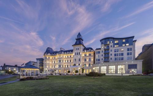 a large building with a grass field in front of it at Royal Marine Hotel in Dun Laoghaire