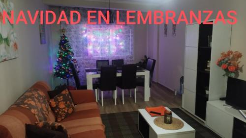 a living room with a christmas tree and a table at Lembranzas in Padrón
