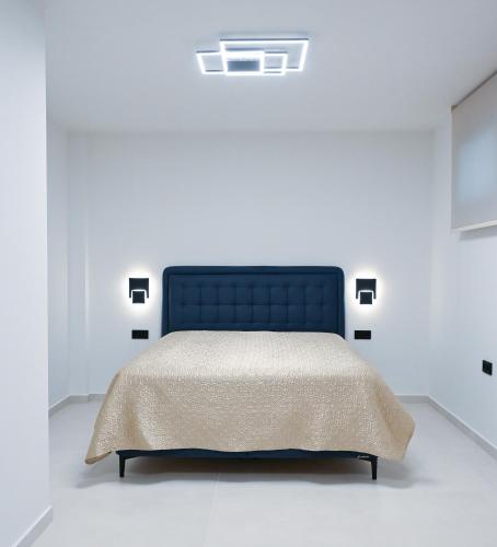 a bedroom with a bed in a white room at Villa Petra in Kavála