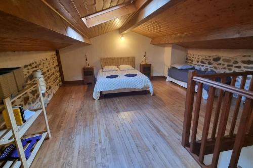 a large room with two beds and a staircase at Au fil de l'eau - Nature in Saint-Floret