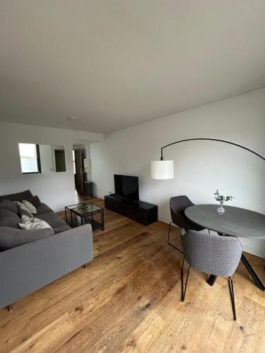 a living room with a couch and a table at La Résidence Amal in Talence