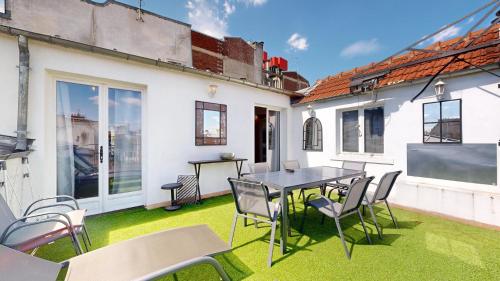a patio with grass and a table and chairs at Bluestay 201 - Superb apartment in Paris in Paris