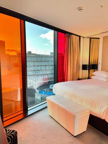 a bedroom with a large window with a view at Crowne Plaza Manchester City Centre by IHG in Manchester