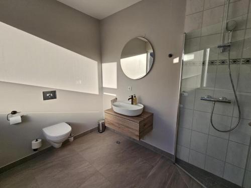 a bathroom with a toilet sink and a shower at Hótel Laugarvatn in Laugarvatn