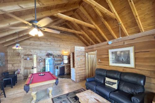 a living room with a couch and a pool table at Honeymoon View #2 in Little Cove