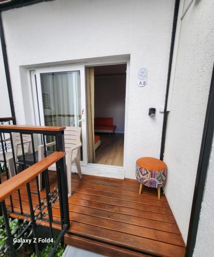 a balcony of a house with a wooden deck at Loca Centre Suites in Bodrum City