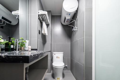 a bathroom with a toilet and a sink at Xi'an Yongning Apartment Hotel in Xi'an