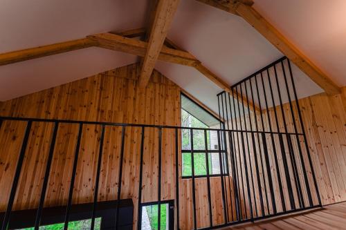 a room with wooden walls and a large window at Vila ZIA in Teşila
