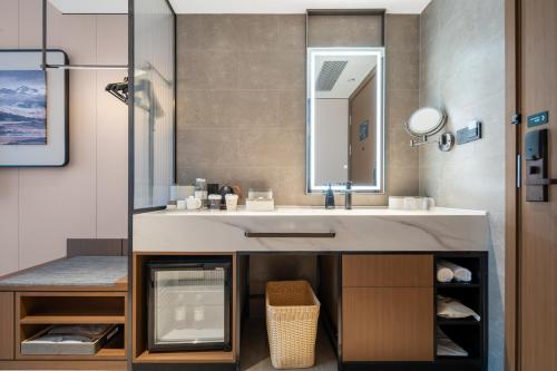a bathroom with a sink and a mirror at Atour Hotel Chongqing Jiangbei Airport Huanshan Park in Chongqing