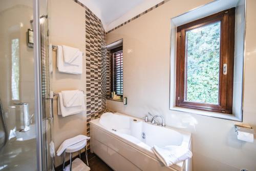 a bathroom with a tub and a sink and a window at Villa Franica in Dubrovnik