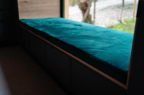 a window seat with a blue sheet on it at Vila ZIA in Teşila