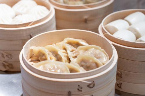 a group of wooden bowls filled with dumplings at Atour Hotel Chongqing Jiangbei Airport Huanshan Park in Chongqing
