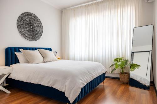 a bedroom with a large bed and a mirror at 2 bedroom Apartment in Ashfield, 200m to train station,Free Parking in Sydney