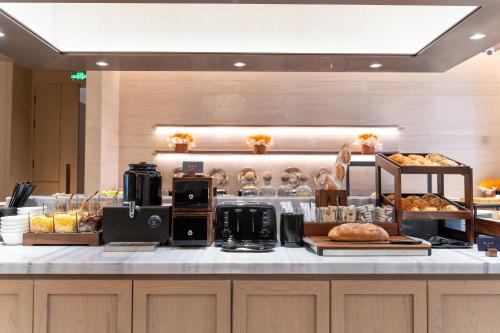 a bakery counter with bread and pastries at Atour Hotel Chongqing Jiangbei Airport Huanshan Park in Chongqing