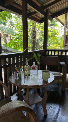 a wooden table with bowls and other items on it at Boon Homestay & Cafe บุญโฮมสเตย์ in Ban Buak Khang