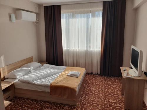 Postel nebo postele na pokoji v ubytování Хотел Радост