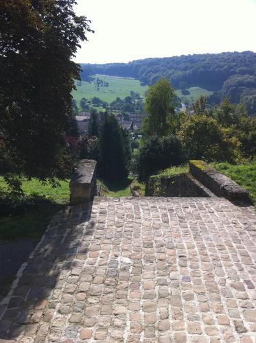 a stone walkway with a view of a valley at Fasthôtel Le Râle Des Genêts - Un hôtel FH Collection in Dun-sur-Meuse