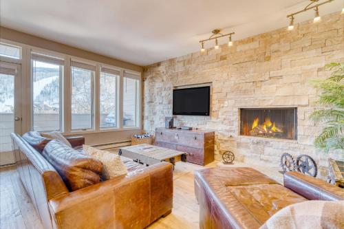 a living room with couches and a fireplace at Sunvail by AvantStay 10min Walk to Ski Lifts in Vail