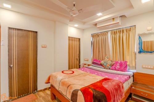 a bedroom with a large bed in a room at Pooja Villa Suites-Rooms and Pool, Igatpuri in Igatpuri