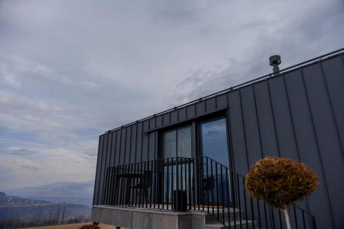 a black house with a balcony on a hill at Shakaryan Rancho&Restaurant in Dsegh