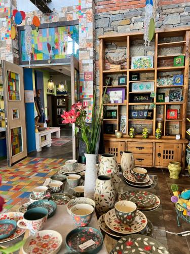 a table with plates and vases on it in a store at Hotel Casa Art in Oreshak