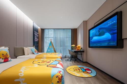 a hotel room with two beds and a flat screen tv at Atour Hotel Chongqing Jiangbei Airport Huanshan Park in Chongqing