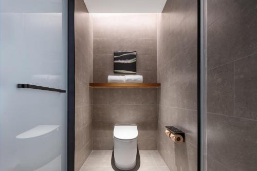 a bathroom with a toilet and a sink at Atour Hotel Chongqing Jiangbei Airport Huanshan Park in Chongqing