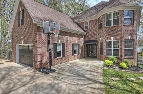 a brick house with a basketball hoop in the driveway at Laid Back Lake Life by AvantStay Waterfront View in Mooresville