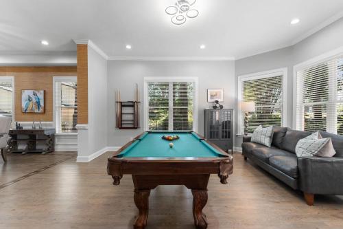 a living room with a pool table and a couch at Laid Back Lake Life by AvantStay Waterfront View in Mooresville