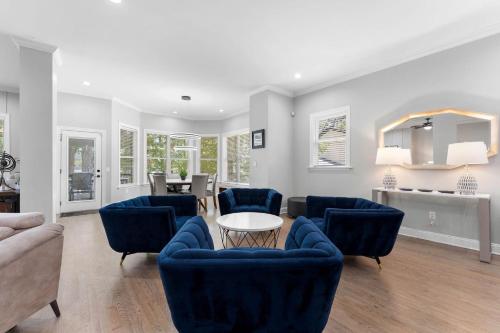 a living room with blue chairs and a table at Laid Back Lake Life by AvantStay Waterfront View in Mooresville
