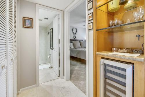 a kitchen with a sink and a bathroom with a bed at Dune Wind South by AvantStay Communal Pool Hot Tub Gated Community Close to Smathers Beach Month Long Stays Only in Key West