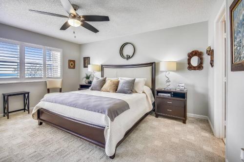 a bedroom with a bed and a ceiling fan at Dune Wind South by AvantStay Communal Pool Hot Tub Gated Community Close to Smathers Beach Month Long Stays Only in Key West