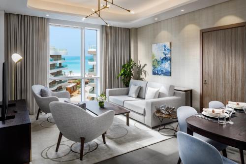 a living room with a couch and a table at Millennium Residences Saadiyat Island in Ḩayl