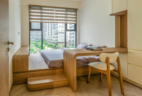 a bedroom with a bed with a window and a chair at Saigon Luxury Apartment in Long Bình
