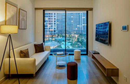 a living room with a couch and a large window at Saigon Luxury Apartment in Long Bình