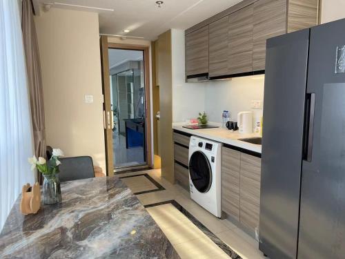 a kitchen with a refrigerator and a washing machine at Shanghai Lerongju Boutique Apartment Metro Line 8 20meter in Shanghai