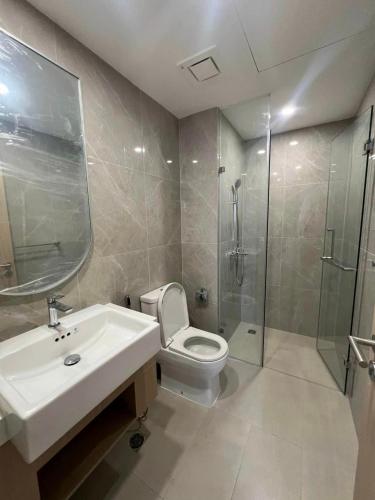 a bathroom with a toilet and a sink and a shower at Saigon Luxury Apartment in Long Bình