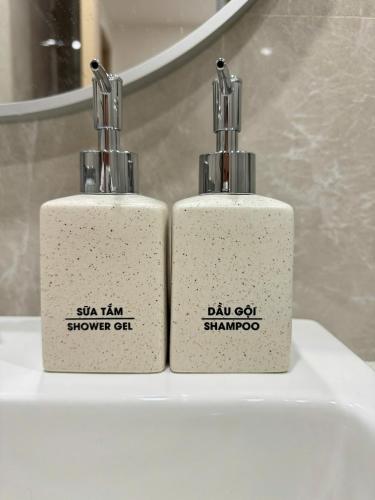 two white bottles sitting on top of a sink at Saigon Luxury Apartment in Long Bình