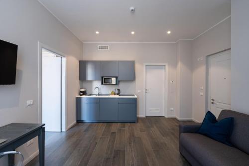 a kitchen with a blue island in a living room at Corte Novella Hotel & Residence in Brescia
