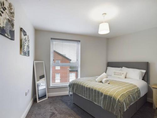 a bedroom with a large bed and a window at Cozy unit in Belfast in Belfast