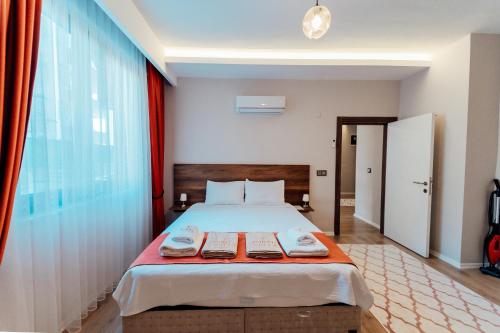 a bedroom with a bed with two towels on it at Fortunella Suites in Finike