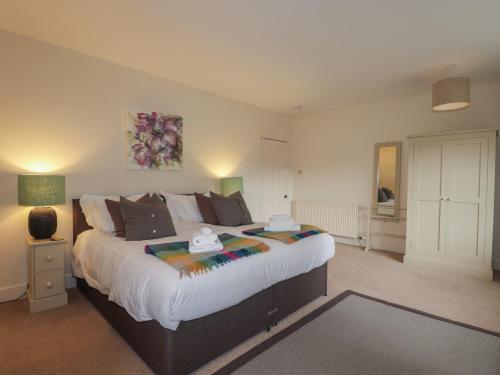 a bedroom with a large bed in a room at Inverewe - Garden Lodge in Achnasheen