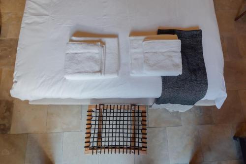 an overhead view of a bathroom with towels and a grate at The Yard Traditional Residence in Vasa Kilaniou