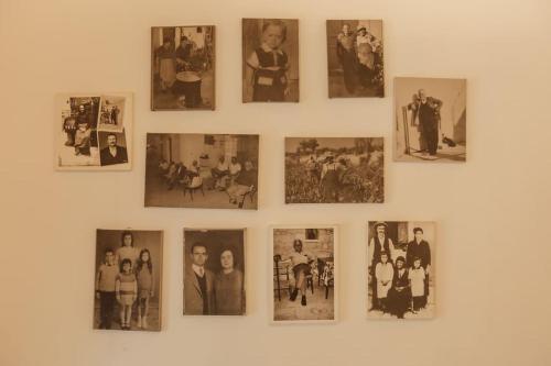 a group of pictures hanging on a wall at The Yard Traditional Residence in Vasa Kilaniou