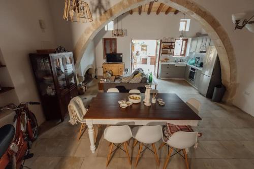 a living room with a table and chairs in a room at The Yard Traditional Residence in Vasa Kilaniou