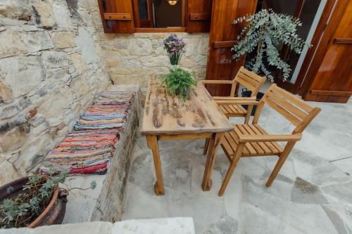 a wooden table and two chairs on a patio at The Yard Traditional Residence in Vasa Kilaniou