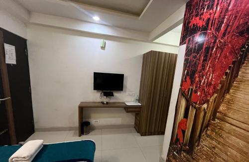 a room with a desk with a computer on it at Western Keys Hotel in Bengaluru