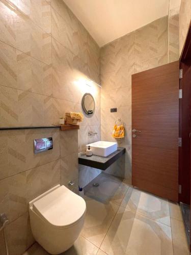 a bathroom with a toilet and a sink at Six Boutique Collection in Mannārgudi