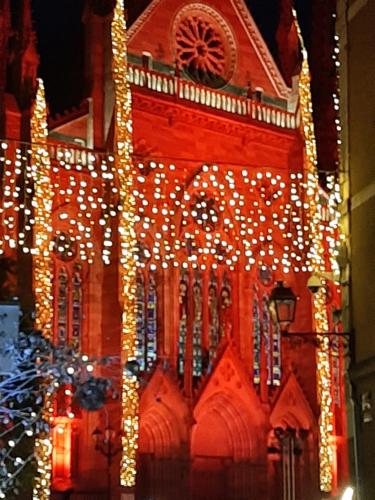 a building with christmas lights on it at Brit Hotel Mulhouse Centre in Mulhouse